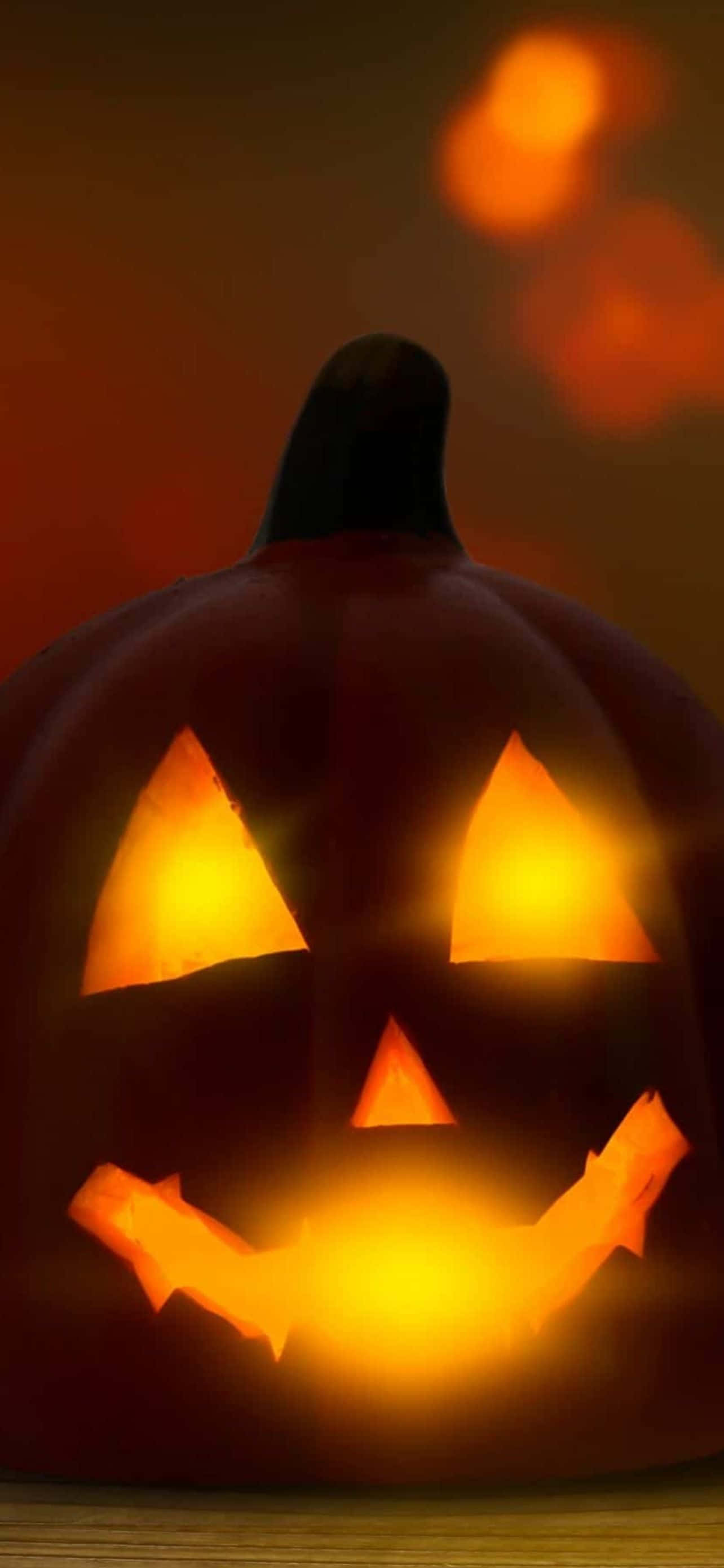 Adaugă puțină distracție înfricoșătoare pe telefonul tău cu un fundal elegant de Halloween pentru iPhone Fundal