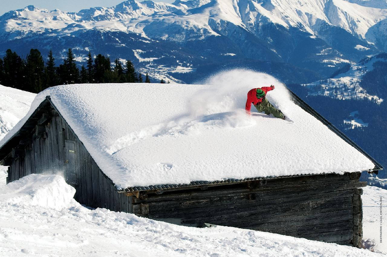 Bărbat cu snowboard care aleargă pe acoperiș Fundal