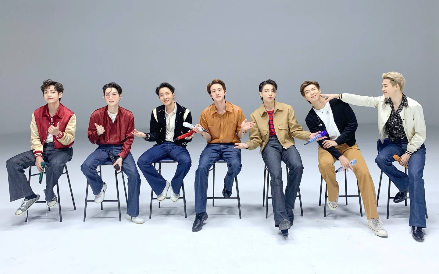 BTS pe desktop pe un rând de scaune tip taburet Fundal