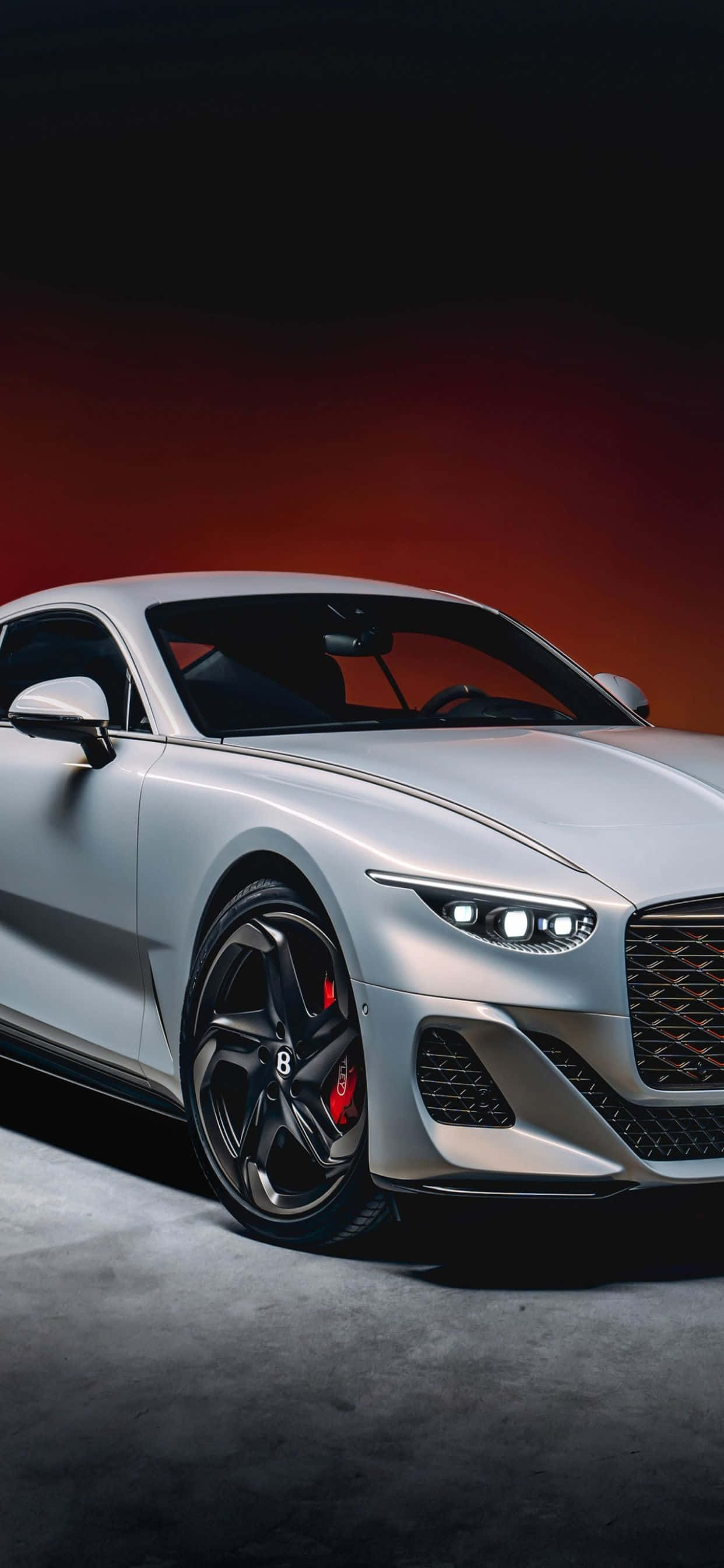 Bucură-te de luxul eleganței și tehnologiei cu acest iPhone Xs MAX într-un Bentley elegant. Fundal