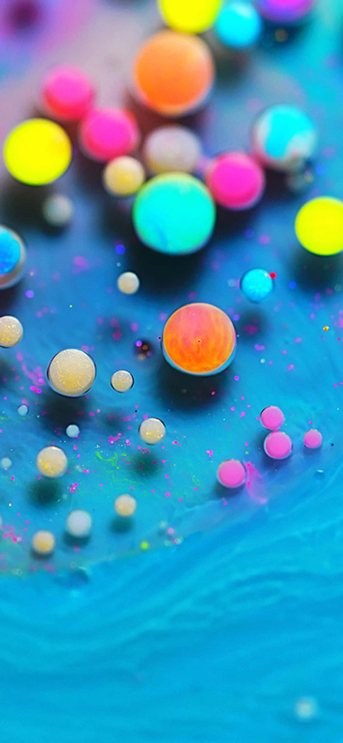 bule colorate care plutesc într-un lichid albastru Fundal