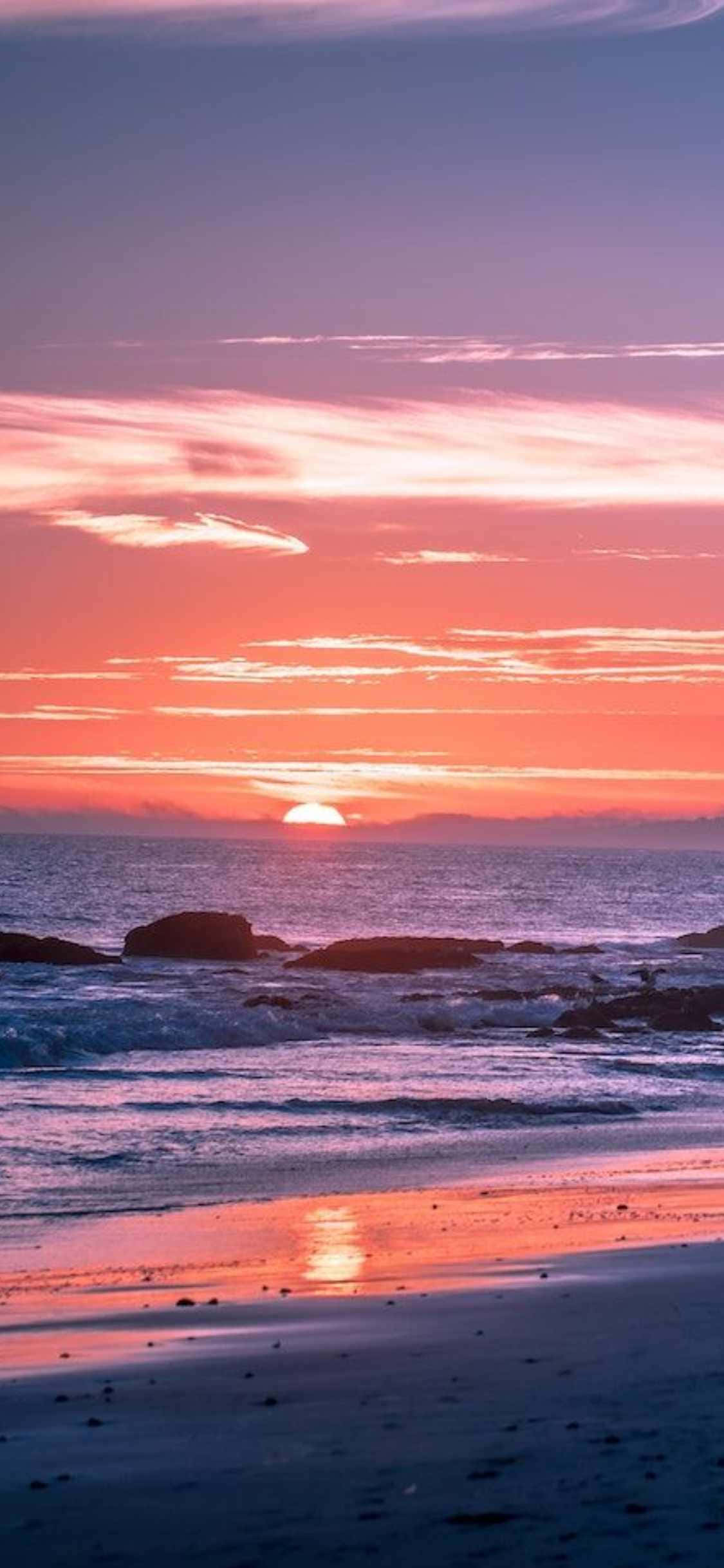 Experimentează frumusețea Malibu-ului cu cel mai recent iPhone Xs Fundal