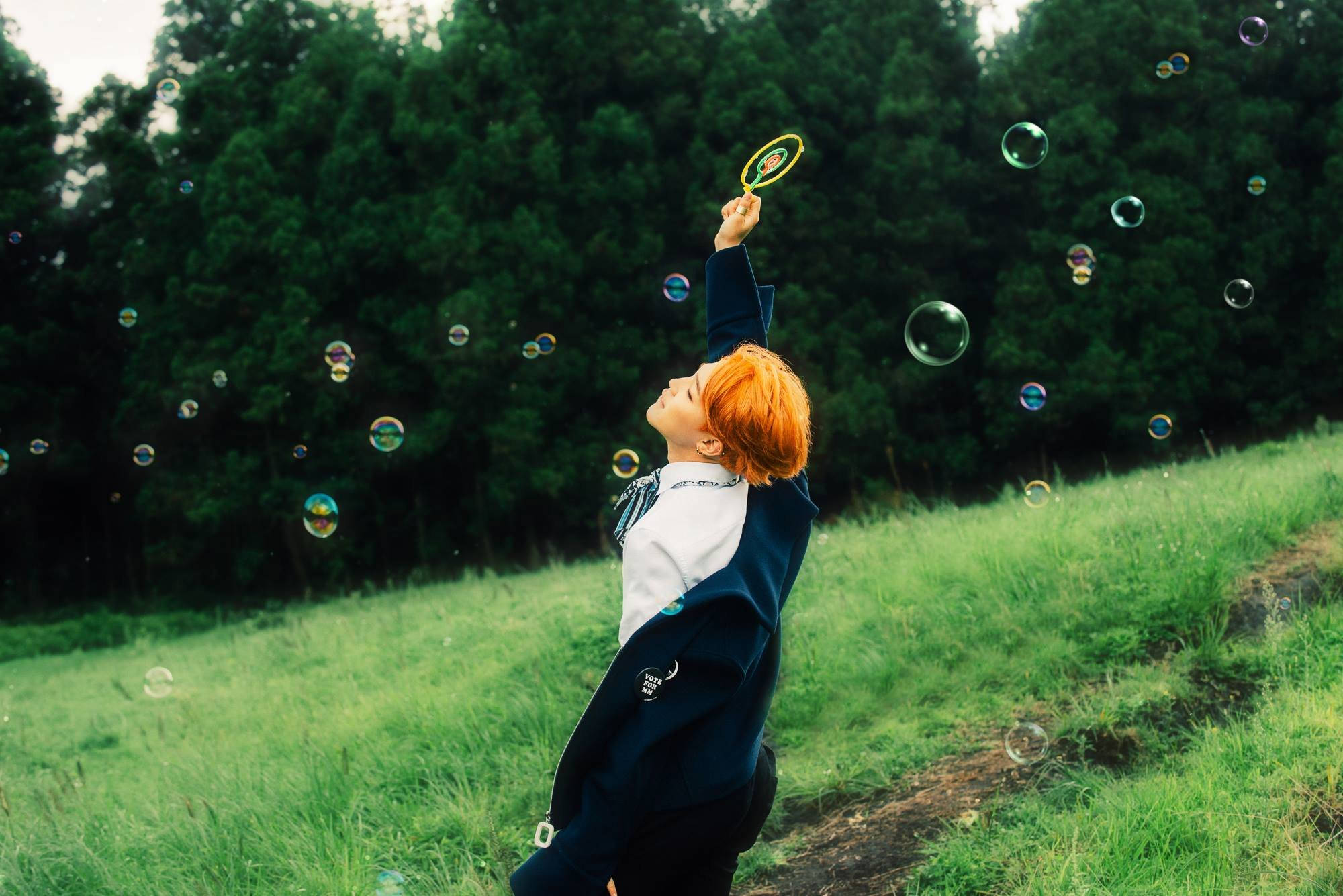 Jimin din BTS savurând bule într-o atmosferă estetică Fundal