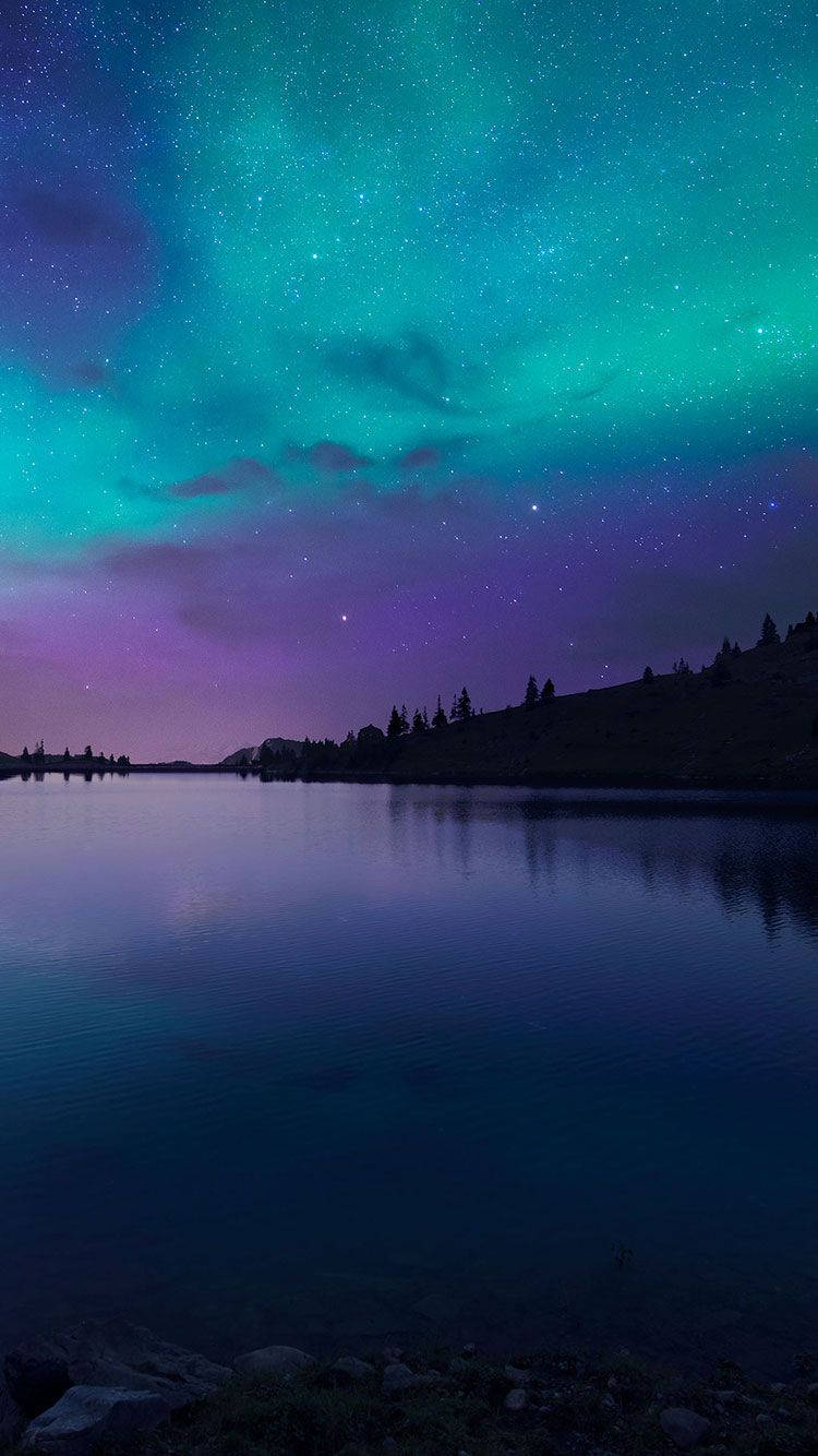 Lumini ale cerului: Un cer nocturn strălucind cu misterioasa auroră boreală Fundal
