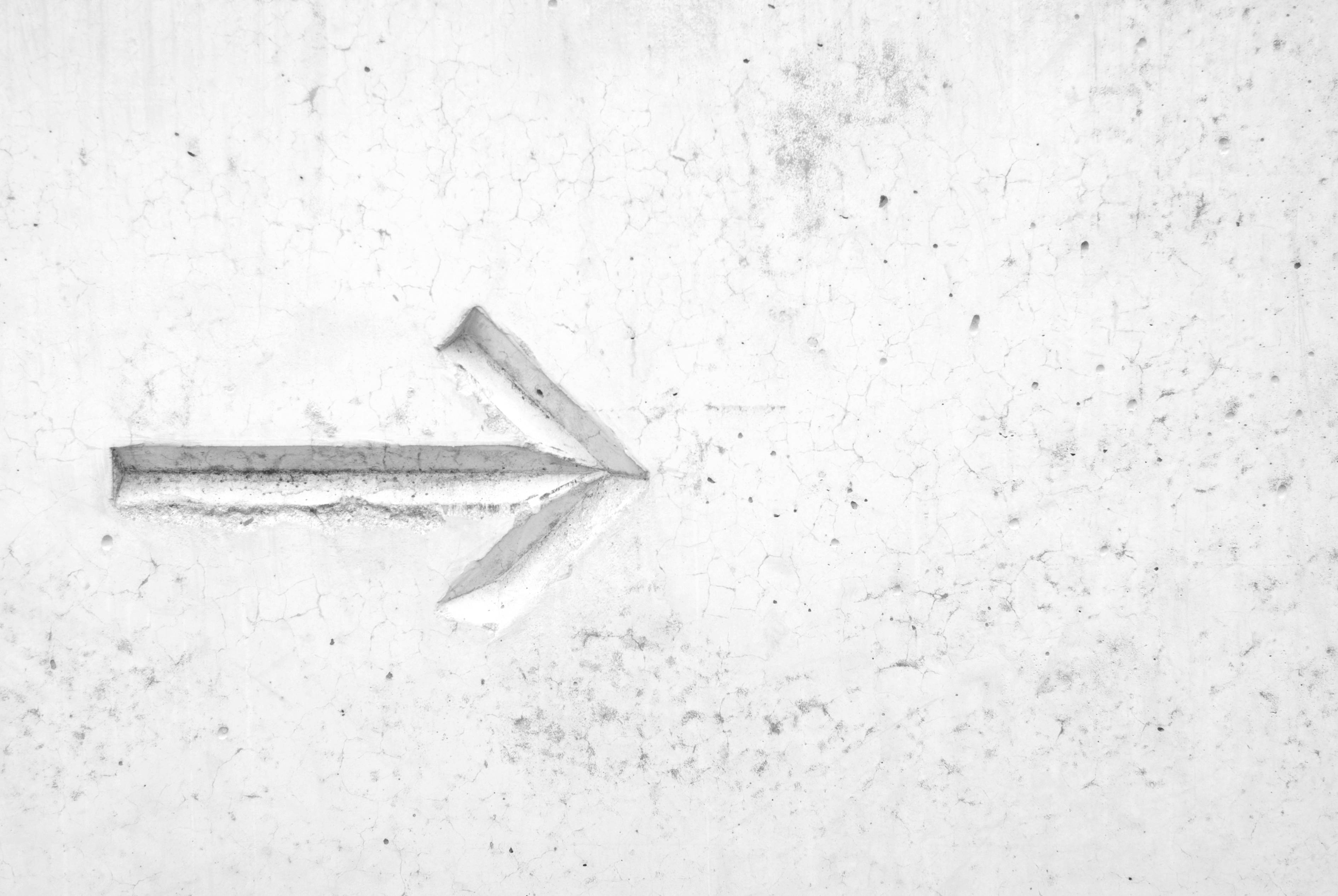 Make your next step with this Right Arrow Sign on a White Wall Fundal