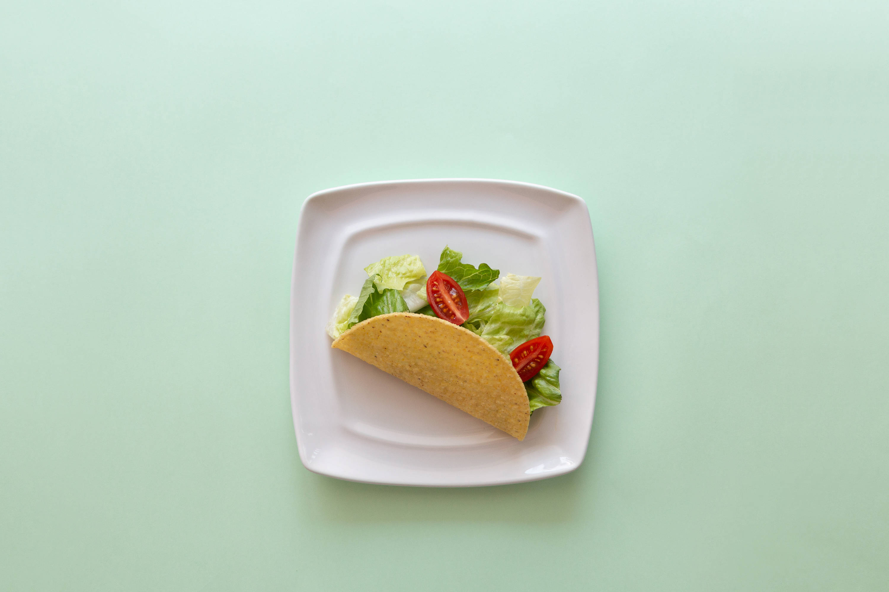 Taco pe masă verde pastel Fundal