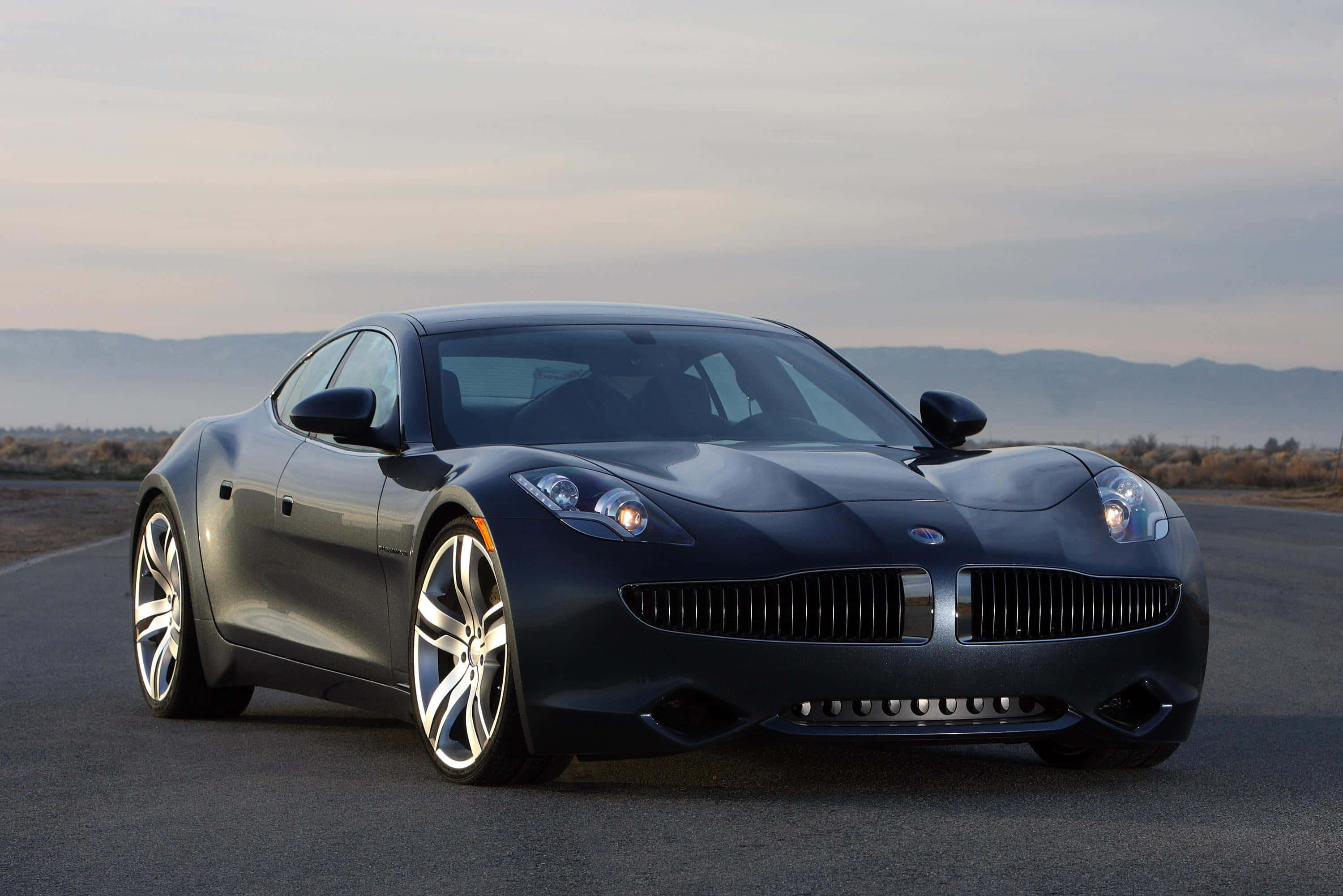 The Fisker Karma, a luxury electric vehicle on a scenic coastal drive. Fundal