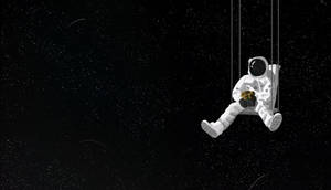 Astronaut atârnat pe laptop întunecat