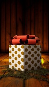 Cadou mare cu buline și fundă roșie, așezat pe podea rustică, luminat de foc. — Cadouri de Crăciun Fundal