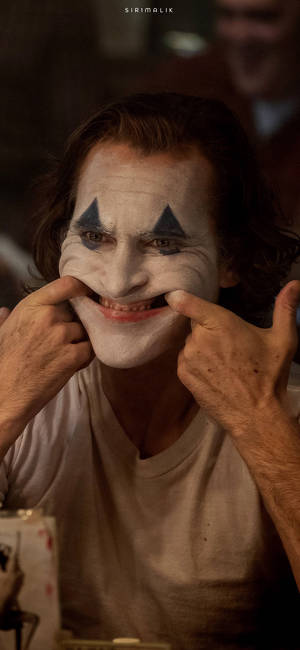 Arthur făcând față zâmbitoare în filmul Joker 2019 fundal — iPhone 12 Pro Fundal