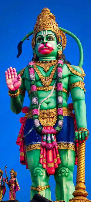 Statuia Gigantică Verde a Zeului Hanuman — iPhone 16 Pro Max Fundal