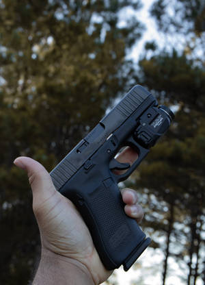 Holding A Glock With Flashlight Wallpaper — OnePlus Pad Fundal